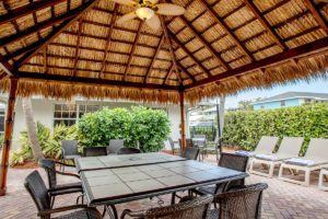 Inside of tiki hut with table and chairs at Seaside Palm Beach