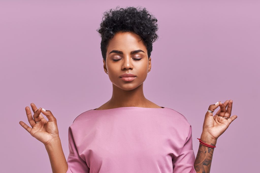 calm woman in pink shirt meditating